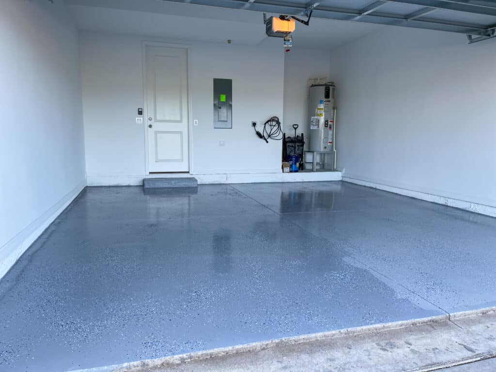 A freshly painted with a gray epoxy finish sprinkled with blue, black and white plastic chips. Install A Garage Floor